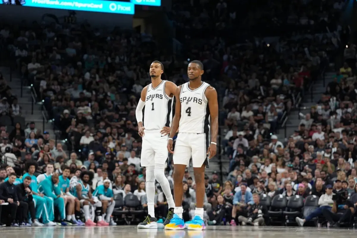 Mar 14, 2026; San Antonio, Texas, USA; San Antonio Spurs forward Victor Wembanyama (1) and guard De'aaron Fox (4) look back up the court in the second half against the Charlotte Hornets at Frost Bank Center. Mandatory Credit: Daniel Dunn-Imagn Images