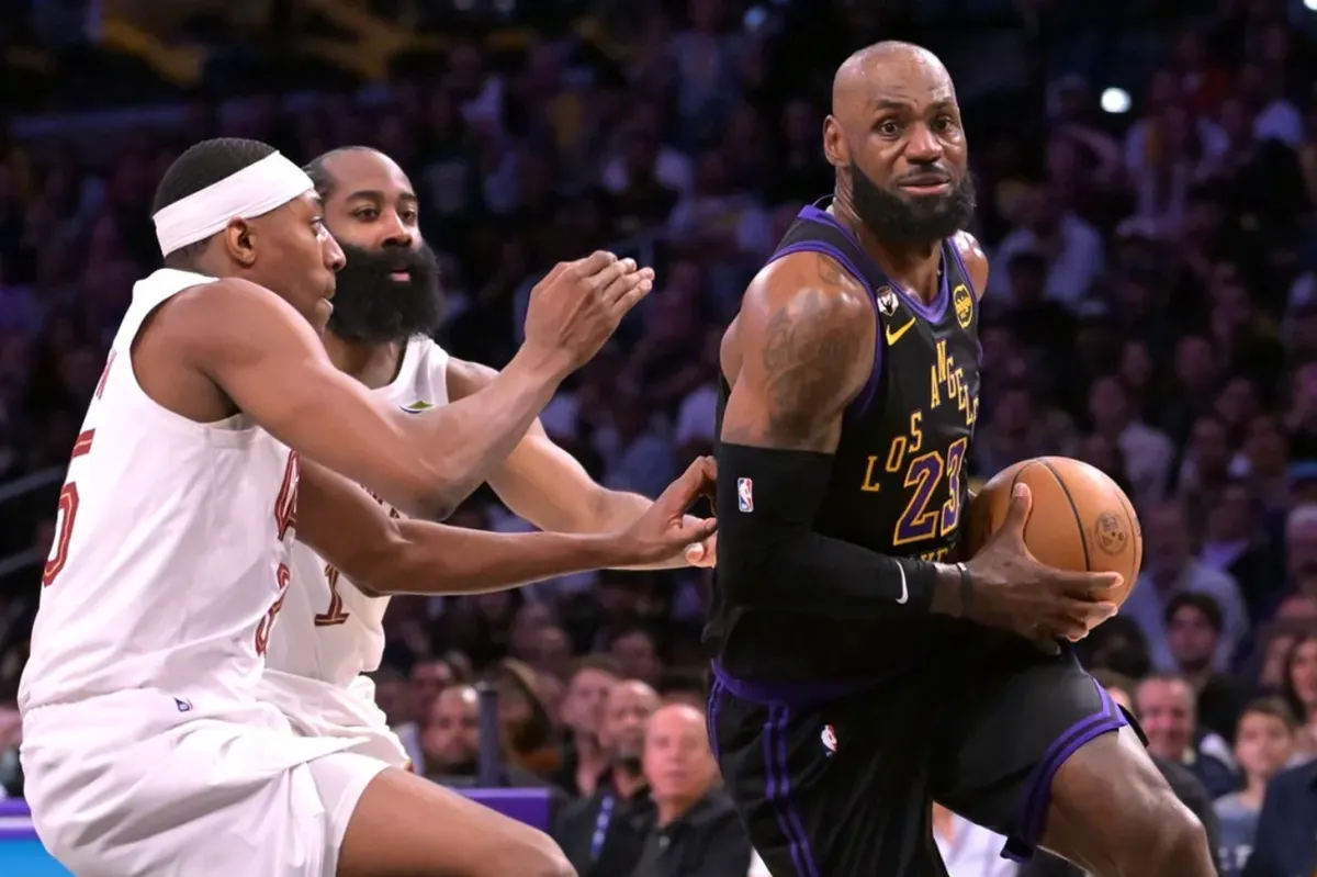 Mar 31, 2026; Los Angeles, California, USA; Los Angeles Lakers forward LeBron James (23) is defended by Cleveland Cavaliers guard James Harden (1) and forward Nae'qwan Tomlin (35) in the first half at Crypto.com Arena. Mandatory Credit: Jayne Kamin-Oncea-Imagn Images
