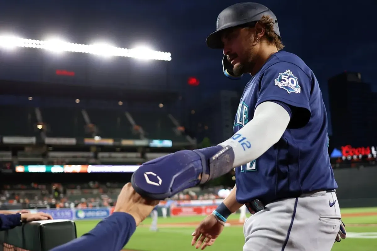 Jun 8, 2026; Baltimore, Maryland, USA; Seattle Mariners first baseman Josh Naylor (12) celebrates with his teammates after scoring a run during the eighth inning against the Baltimore Orioles at Oriole Park at Camden Yards. Mandatory Credit: Daniel Kucin Jr.-Imagn Images
