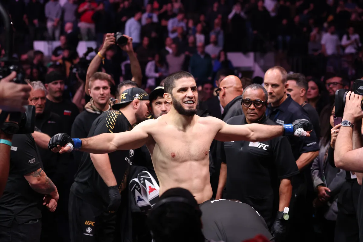 Nov 15, 2025; New York, NY, UNITED STATES; Islam Makhachev (blue gloves) walks in before the welterweight championship bout against Jack Della Maddalena (not pictured) during UFC 322 at Madison Square Garden. Mandatory Credit: Ed Mulholland-Imagn Images