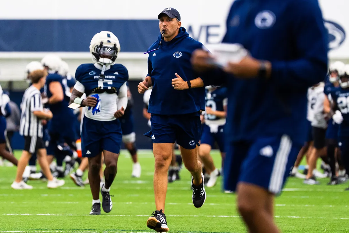 Penn State football head coach Matt Campbell jogs at the start of a practice session inside Holuba Hall on Monday, August 10, 2026, in State College.