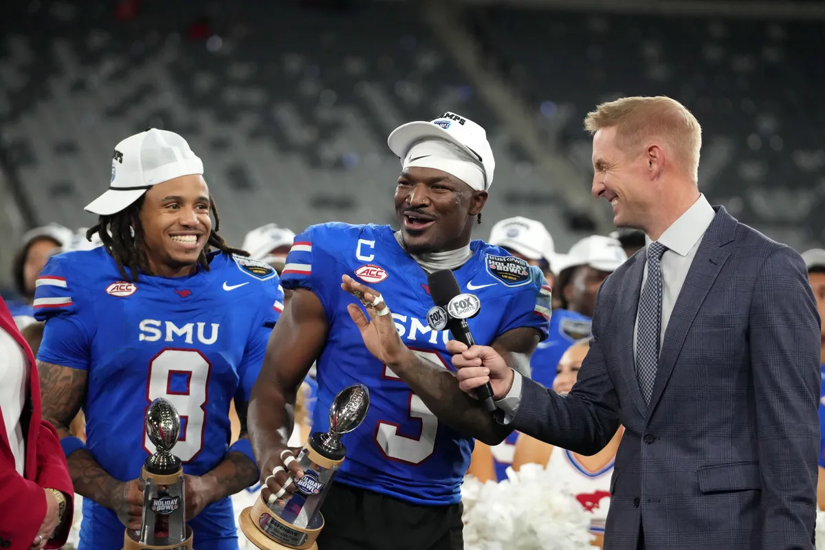 Jan 2, 2026; San Diego, CA, USA; SMU Mustangs wide receiver Yamir Knight (8) and safety Ahmaad Moses (3) are interviewed by Fox Sports broadcaster Joel Klatt after the Holiday Bowl against the Arizona Wildcats at Snapdragon Stadium. Mandatory Credit: Kirby Lee-Imagn Images