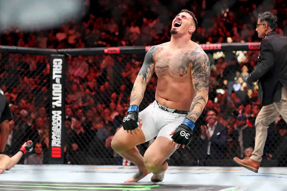 Nov 11, 2023; New York, NY, USA; Tom Aspinall (blue gloves) reacts to beating Sergei Pavlovich (red gloves) during UFC 295 at Madison Square Garden. Mandatory Credit: Wendell Cruz-USA TODAY Sports