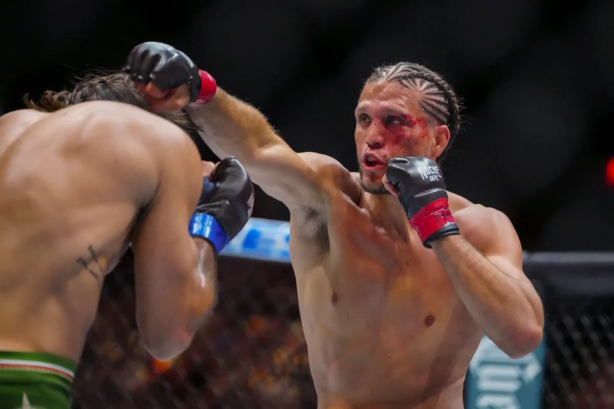 Sep 14, 2024; Las Vegas, Nevada, USA; Brian Ortega of the United States (red gloves) fights Diego Lopes of Brazil (blue bloves) during Riyadh Season Noche UFC 306 at The Sphere. Mandatory Credit: Stephen R. Sylvanie-Imagn Images