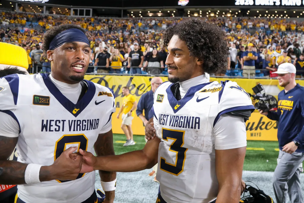 Sep 19, 2026; Charlotte, North Carolina, USA; West Virginia Mountaineers tight end Josh Sapp (0) celebrates with West Virginia Mountaineers quarterback Michael Hawkins Jr. (3) after defeating the Virginia Cavaliers at Bank of America Stadium. Mandatory Credit: Ben Queen-Imagn Images