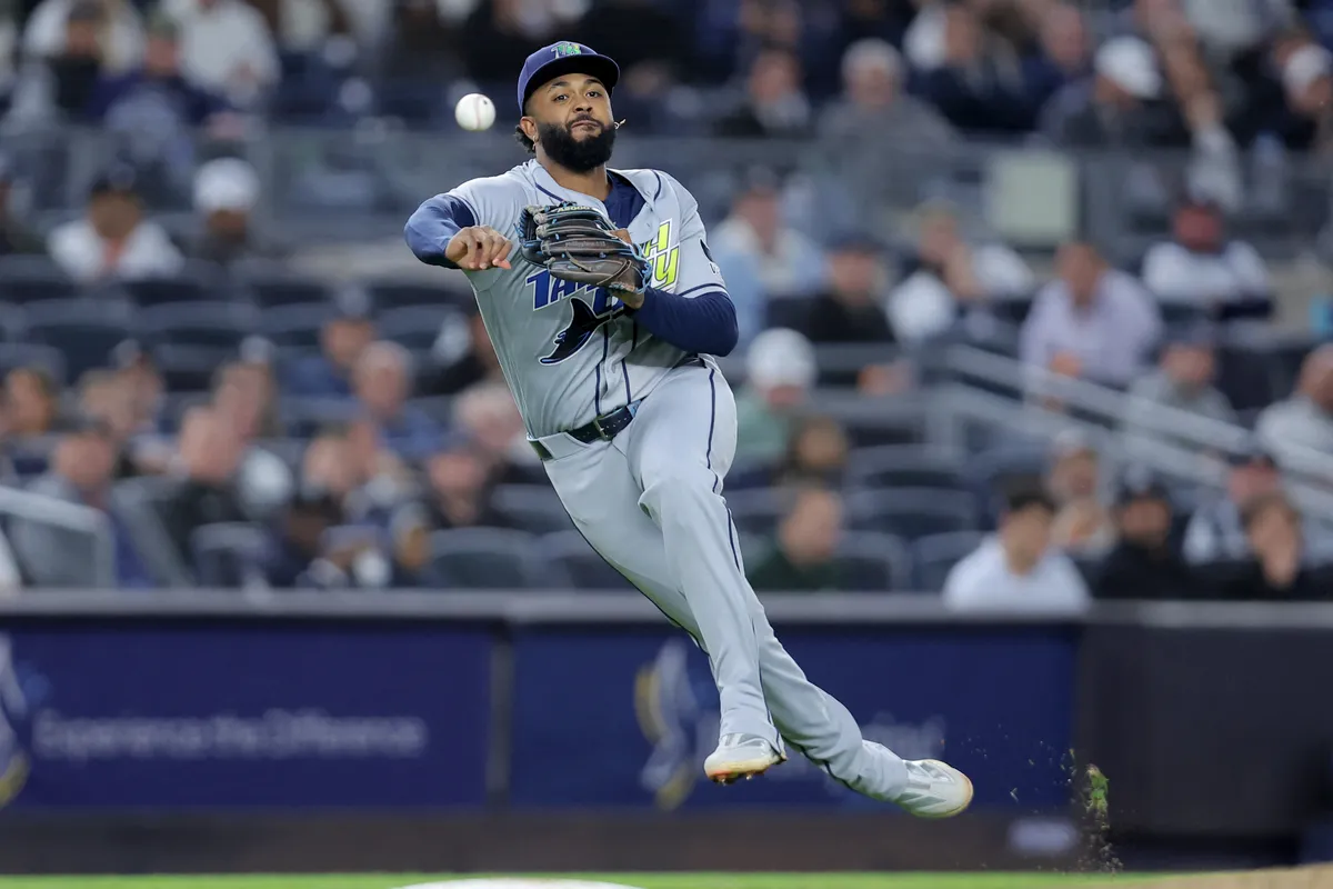 Sep 24, 2026; Bronx, New York, USA; Tampa Bay Rays third baseman Junior Caminero (13) throws out New York Yankees third baseman Amed Rosario (not pictured) on a ground ball during the seventh inning at Yankee Stadium. Mandatory Credit: Brad Penner-Imagn Images